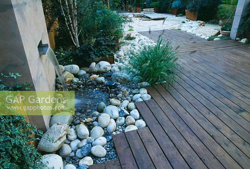 Roof garden with bamboo fencing, white boulders, red cedar decking and water feature