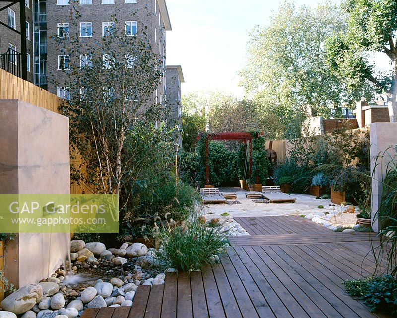 Roof garden with bamboo fence, water feature, white boulders, red cedar deck, bamboo seats and barleycorn gravel