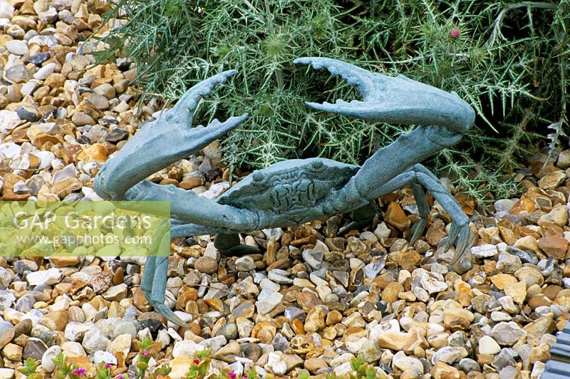 Seaside garden in Guernsey with bronze crab in gravel