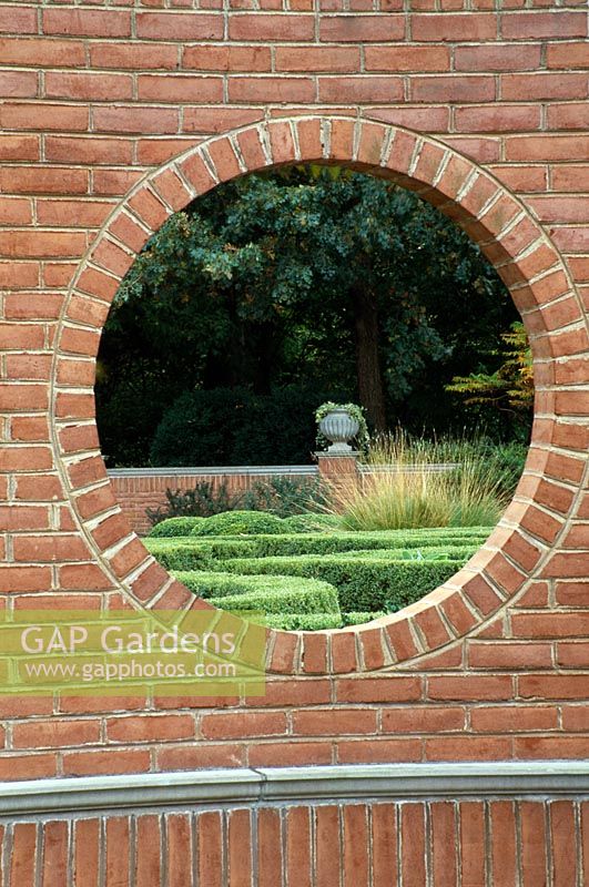 View through a brick wall to an urn - The Blanke Boxwood Garden at the Missouri Botanic Garden, St Louis, USA