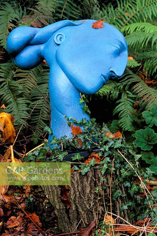 Blue sculpture by Patricia Volk - face in woodland at Greystone cottage, Oxfordshire