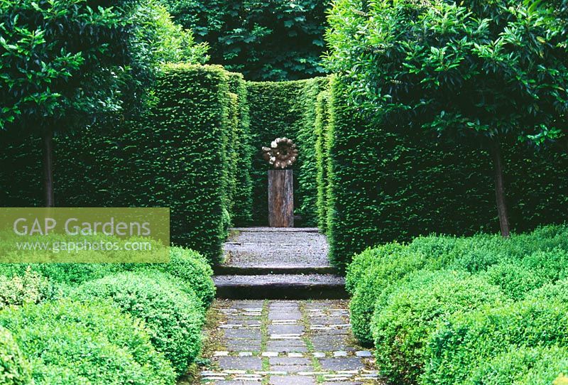 Vista along path to focal point with Buxus - Box balls and Taxus - Yew hedging, Design Tony Ridler
