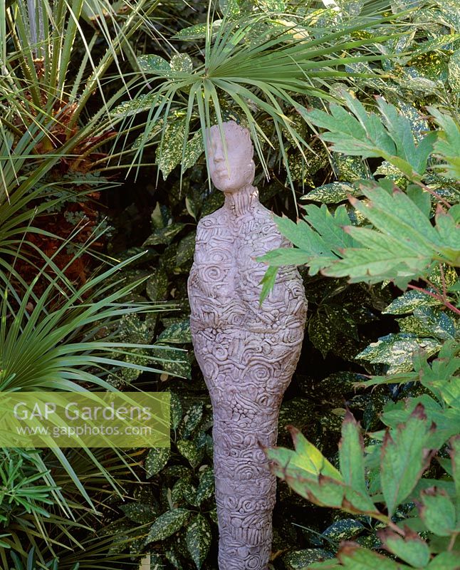 'Papoose' sculpture by Pam Foley surrounded by Trachycarpus and Aucuba at The Galaxie Hotel, Oxford
