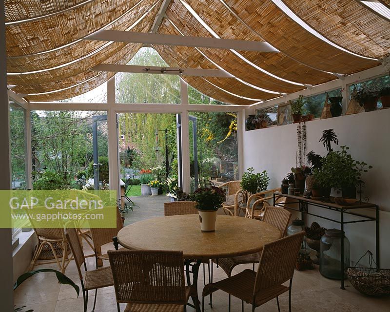 View from inside conservatory with shade blinds to garden, Design Lisette Pleasance