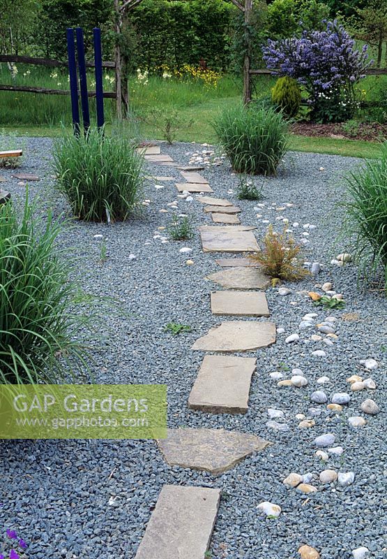 Irregular slab path through gravel garden - Merriments Garden, Sussex