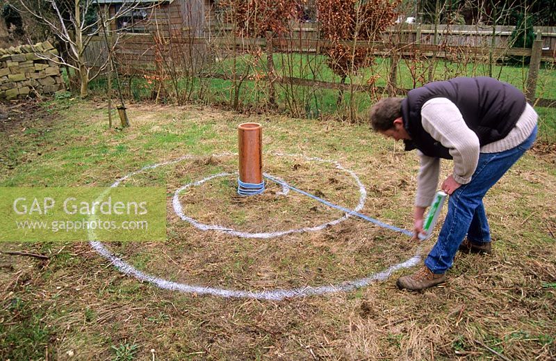 Marking out spiral on ground with marking paint - to plant bulbs by