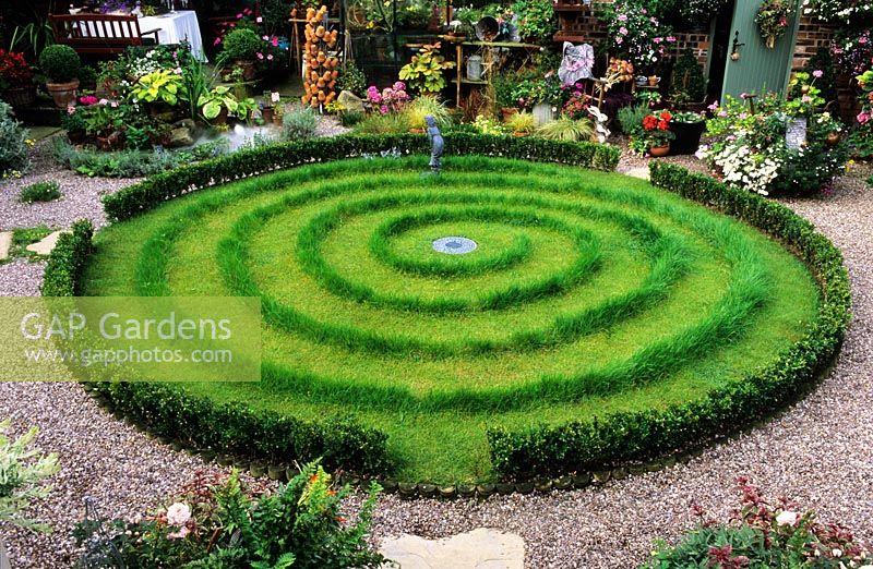 Circular lawn with spiral mown pattern in a decorated garden - Chester 
