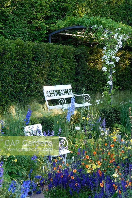 Delphinium, Salvia, Aquilegia ,Geum, white seats and pergola in sunken Garden inspired by Karl Foerster - The Daily Telegraph Garden, Chelsea 2007 