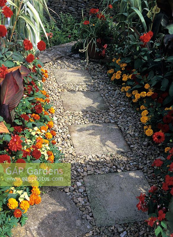 Stepping stone slab path with crushed stone surround at The Barn House, Wiltshire
