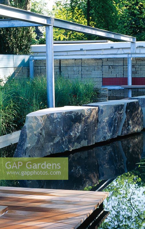 Metal girders natural rock decking and Miscanthus in modern water garden. The Daily Telegraph/RF Hotel's 'Living Sculpture garden'