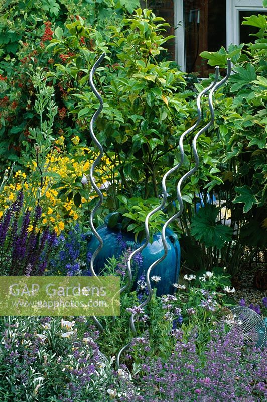 Metal spirals in  seaside style garden, London