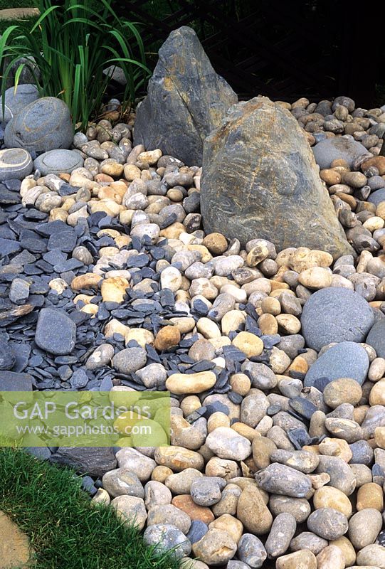 Japanese garden with stones and pebble path