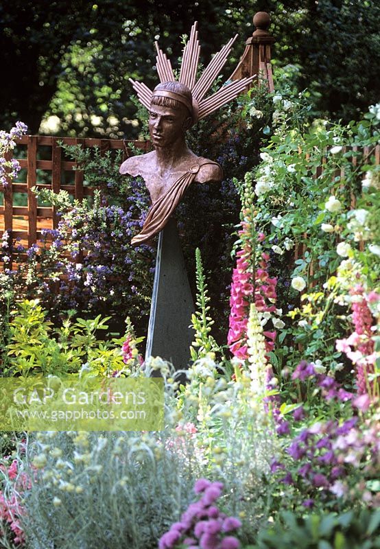 Bronze head and shoulder 'Helios' sculpture in flowerbed - Godstone gardners club, Chelsea 2000