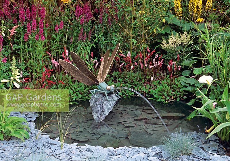Bronze cast Water feature  of Dragonfly on leaf splashing water into informal pond