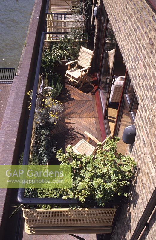 London riverside balcony garden with raised beds, decking and chair