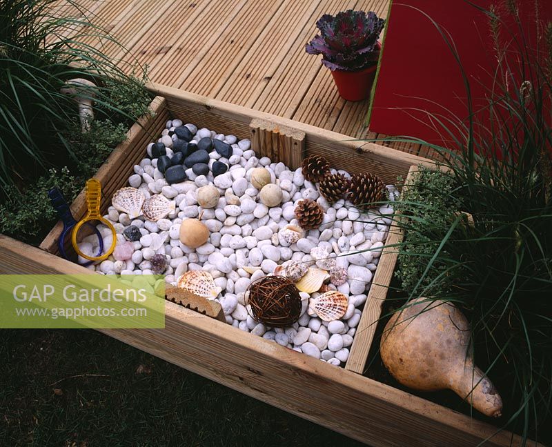 Childrens decking garden, sensory box with pebbles, cones, shells