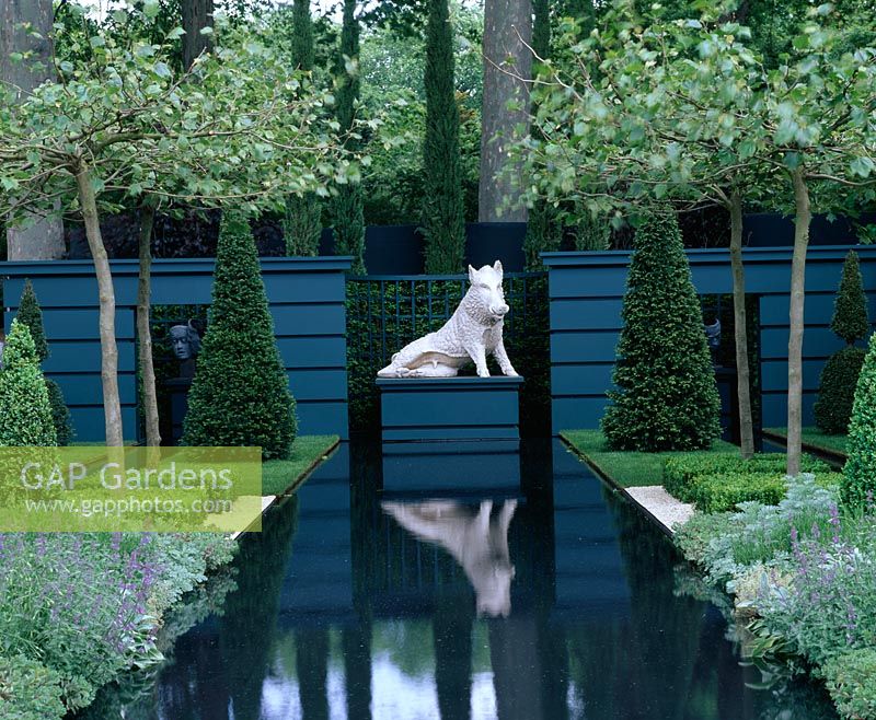 Rectangular water canal with plinth and boar sculpture surrounded by topiary yews and Platanus acerifolia - Christie's Sculpture in The Garden, Chelsea FS