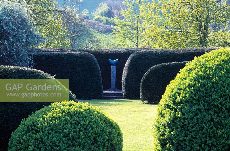 Bridget McCrum's Bronze sculptures at Hamblyn's Coombe, placed in Garden setting of Yew and Box Hedging, Devon