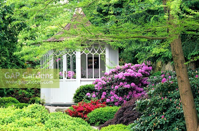 Pavillon in garden with Rhododendrons