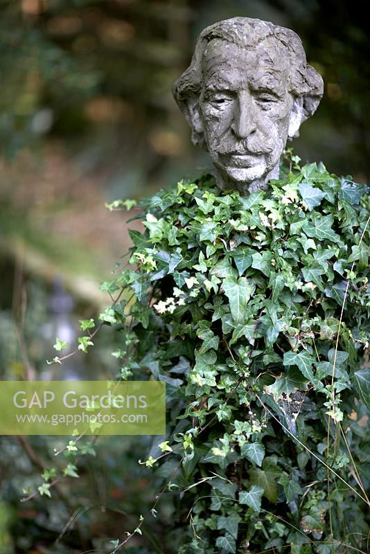 Bust of Sir Frederick Gibberd, sculpture covered in ivy.