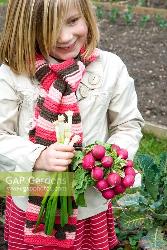 Girl holding bunch of Radishes 
