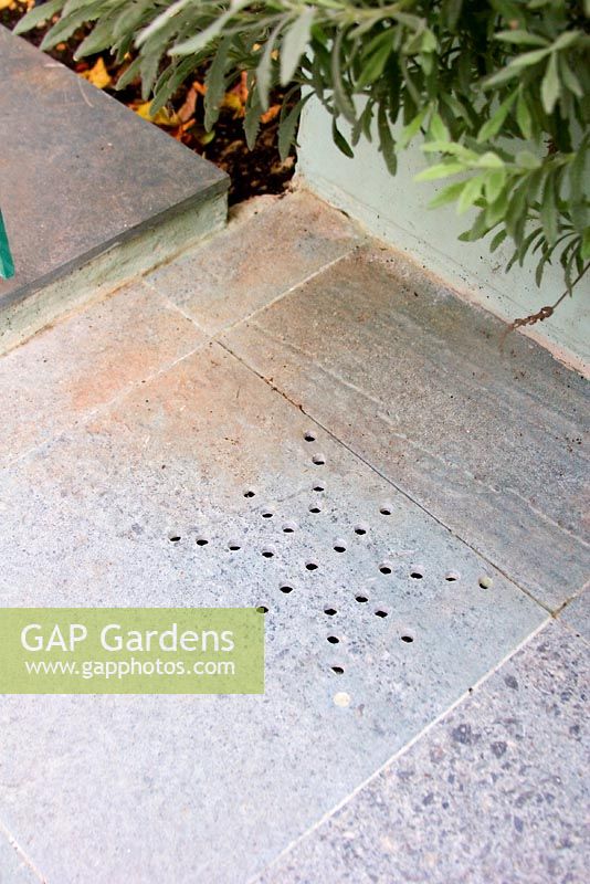 Hole patterns in stone paved path - Cheltenham Terrace London