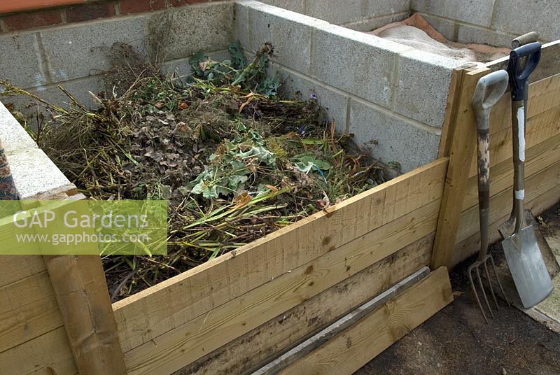 Organic compost in purpose built bay, showing removable retaining boards for access