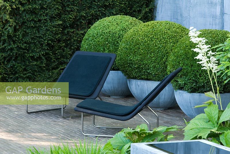 Garden chairs and topiary Buxus balls in zinc containers - The Laurent Perrier Garden - Winner of Gold Medal and Best Show Garden RHS Chelsea Flower Show 2008