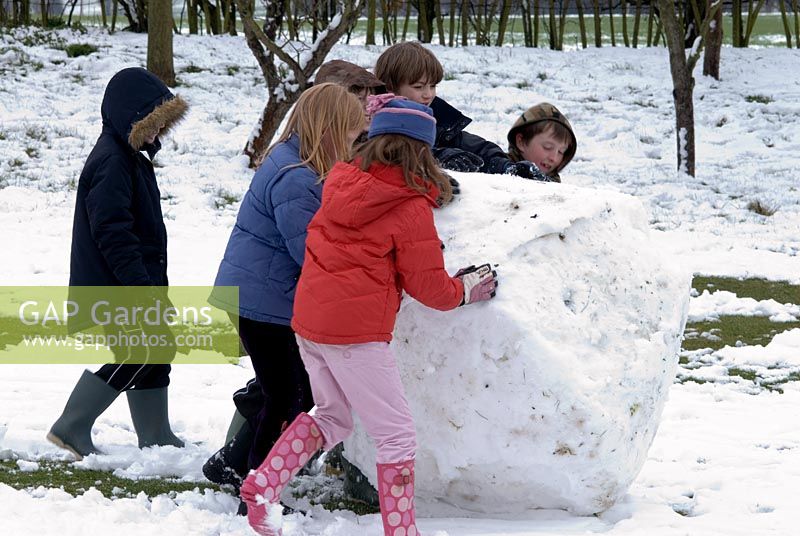 Children making a giant snowball