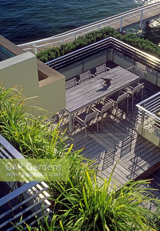 Coastal terrace garden with wooden decking and seating area - Australia