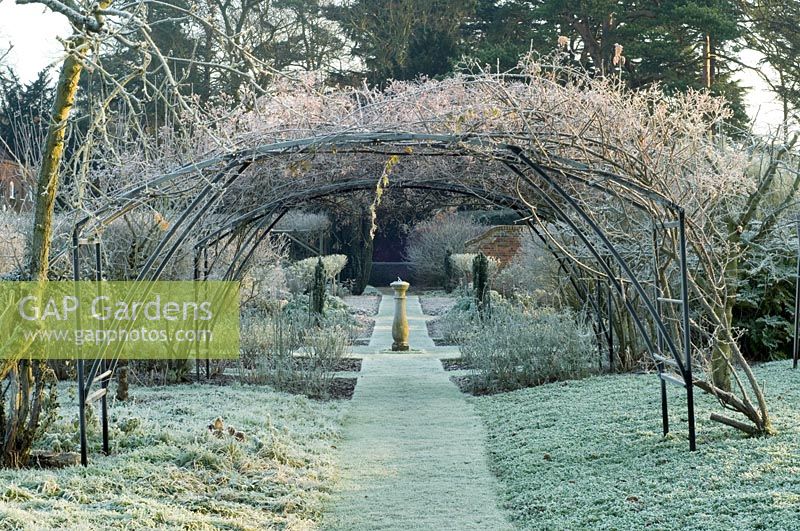 Frosty winter garden with arch and sundial as focal point - Spencers, Great Yeldham, Essex