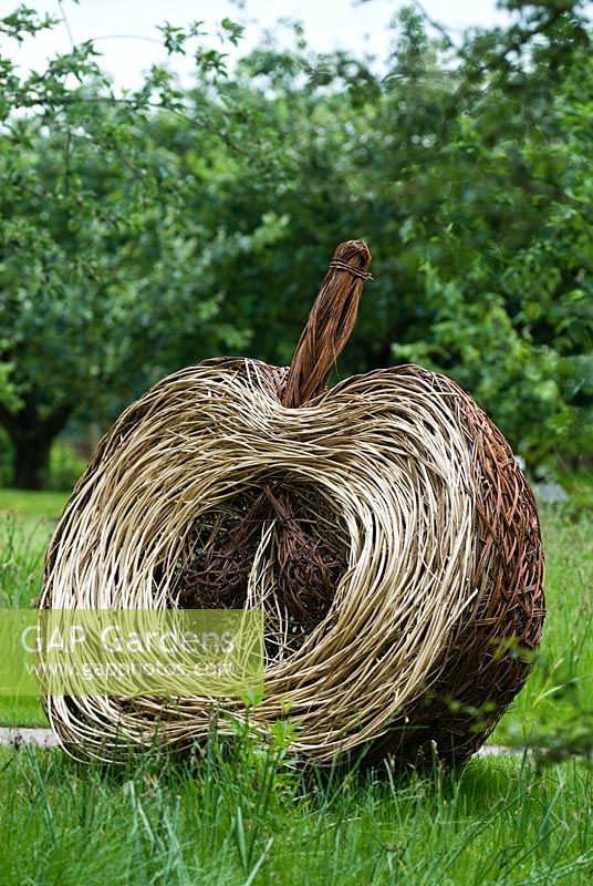 Woven willow apple sculpture in an orchard - RHS Gardens Wisley 