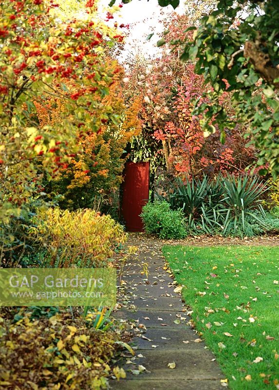 Walled garden with path view showing Autumn mixed border - Saling Hall