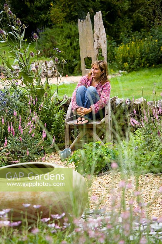 Clare Matthews sits on the throne in her gravel garden in Devon