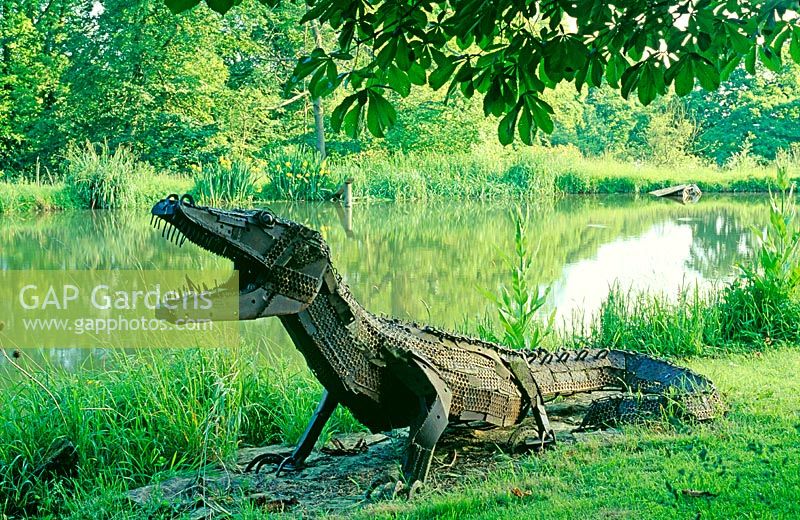 Crocodile beside lake in private garden- Artist Sophie Huges, Oxon