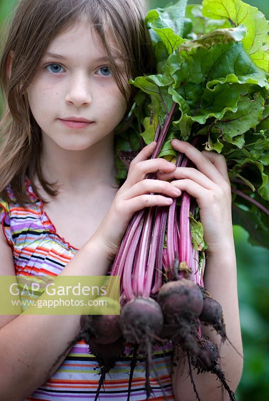 Girl holding a bunch of beetroot