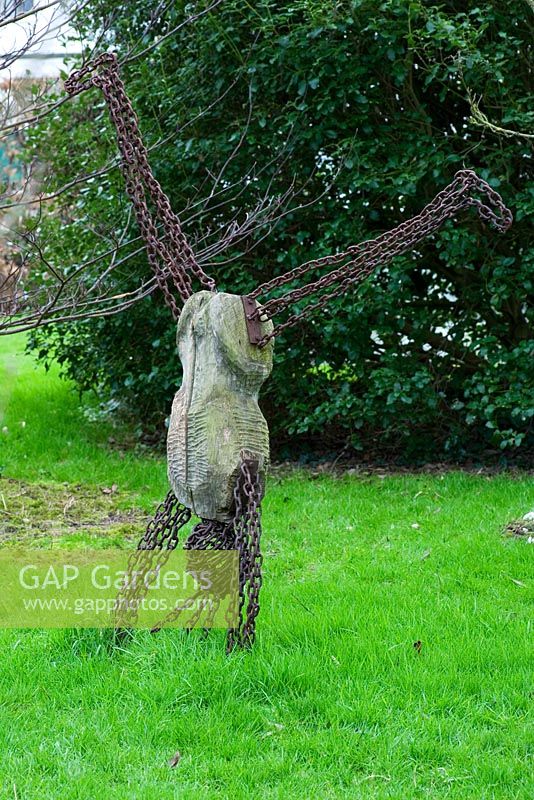 Sculpture of man doing a handstand on lawn - Woodpeckers, Warwickshire