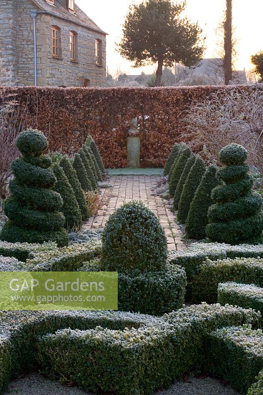 Formal knot garden with Buxus topiary shapes, brick path, statue and Beech hedge - Woodpeckers, Warwickshire