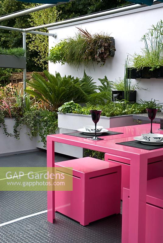 Pink metal table and chairs in rooftop garden - Living on the Ceiling 'No more room down there' Garden - Hampton Court Flower Show 2008