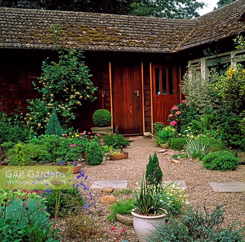 Gravel patio with dwarf conifers, perennials and flagstone path  - Cedar Lodge NGS 