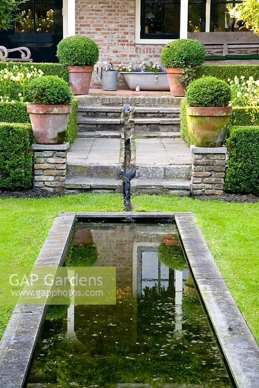 Rill leading from terrace to pond in lawn