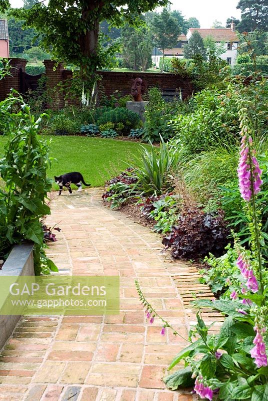 Reclaimed brick path laid in basketweave pattern in garden designers private garden