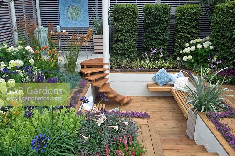The Sadolin Four seasons Garden showing Sunken deck area with seating and Spiral staircase - RHS Hampton Court Palace Flower Show 2008 - Gold medal
