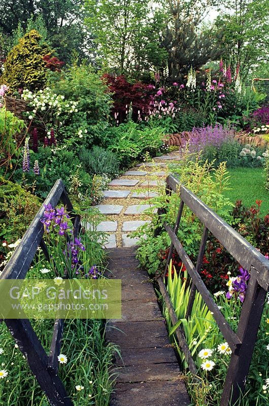 Timber bridge and pathway leading to flower beds