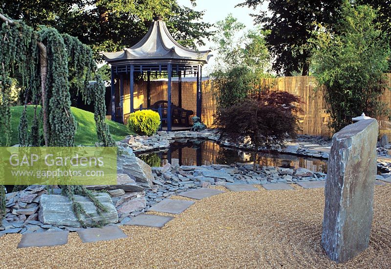 Japanese style garden showing pool edged with slate and pagoda summerhouse in the background at the Hampton Court Flower Show
