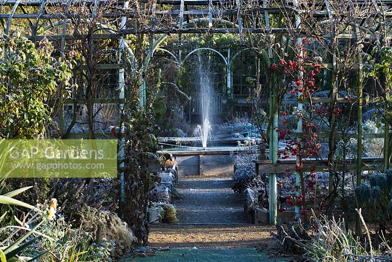 Winter gardens with water fountain and pollarded shrubs - Abbey House Gardens, Malmesbury, Wiltshire