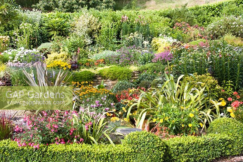 Summer flower borders at Little Larford Cottage in Worcestershire