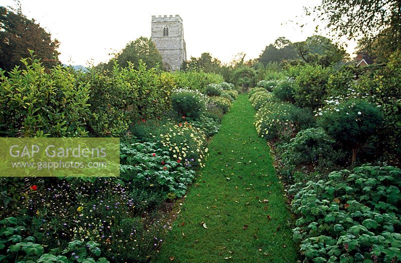 Church walk bedded out with Antirrhinum 'Liberty Crimson', Argyranthemum 'Vanilla Ripple', Pelargoniums and Felicia - Cranborne Manor Garden, Cranborne, Dorset 