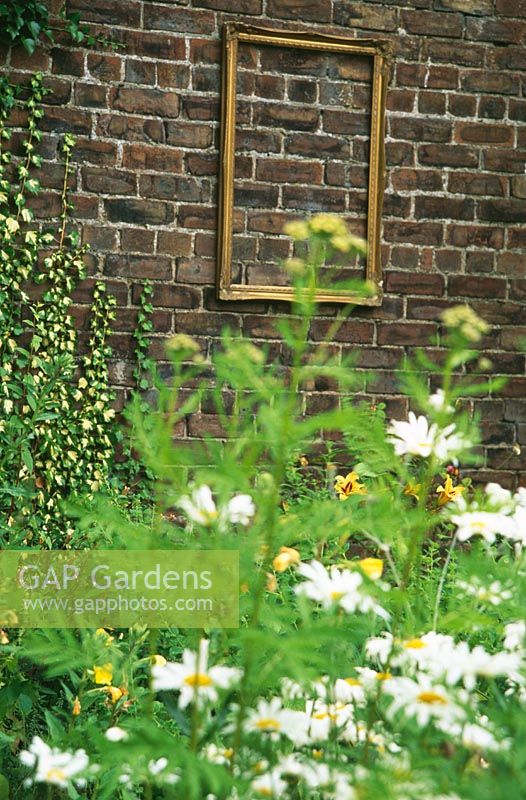 Gold picture frame on garden wall - Hydro Community Garden, Queen Elizabeth High School, Hexham, Northumberland
