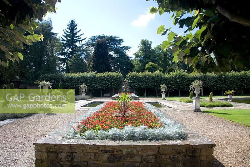 Raised bed with Pelargoniums and stone urns in the Italian Garden at Arley Arboretum, Worcestershire, by kind permission of the Trustees of the R D Turner Charitable Trust